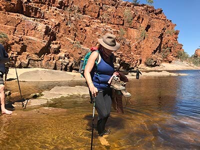 Completing-the-Larapinta-Trail-creek-crossing-boots-off